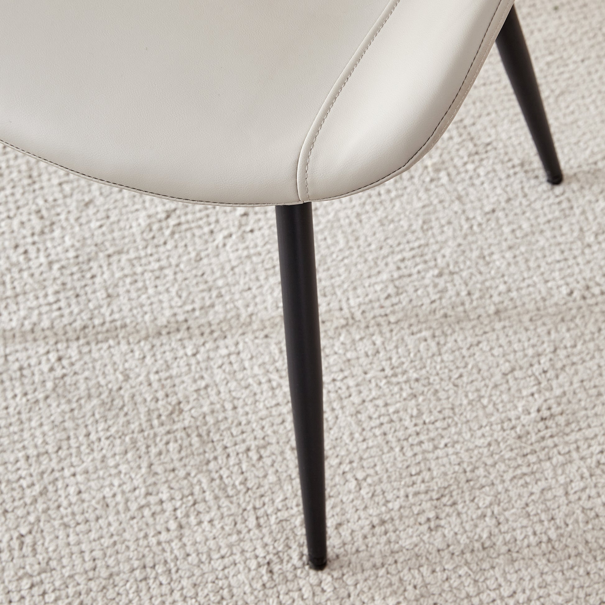 Cream faux leather dining chair with black metal legs