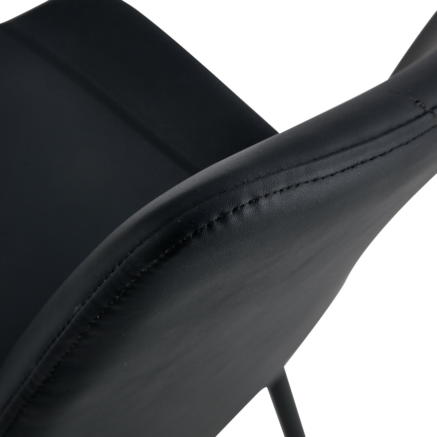 Black faux leather armchair closeup showing stitched seam detail