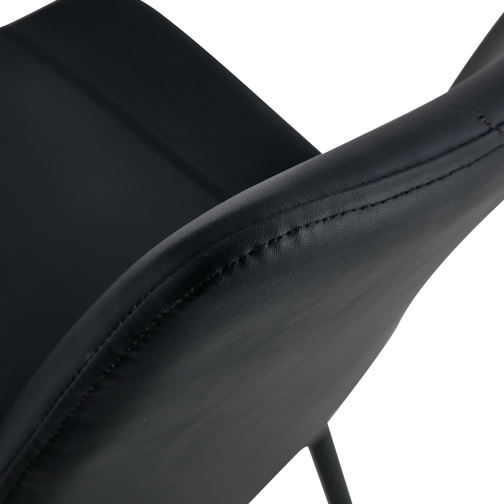 Black faux leather armchair closeup showing stitched seam detail