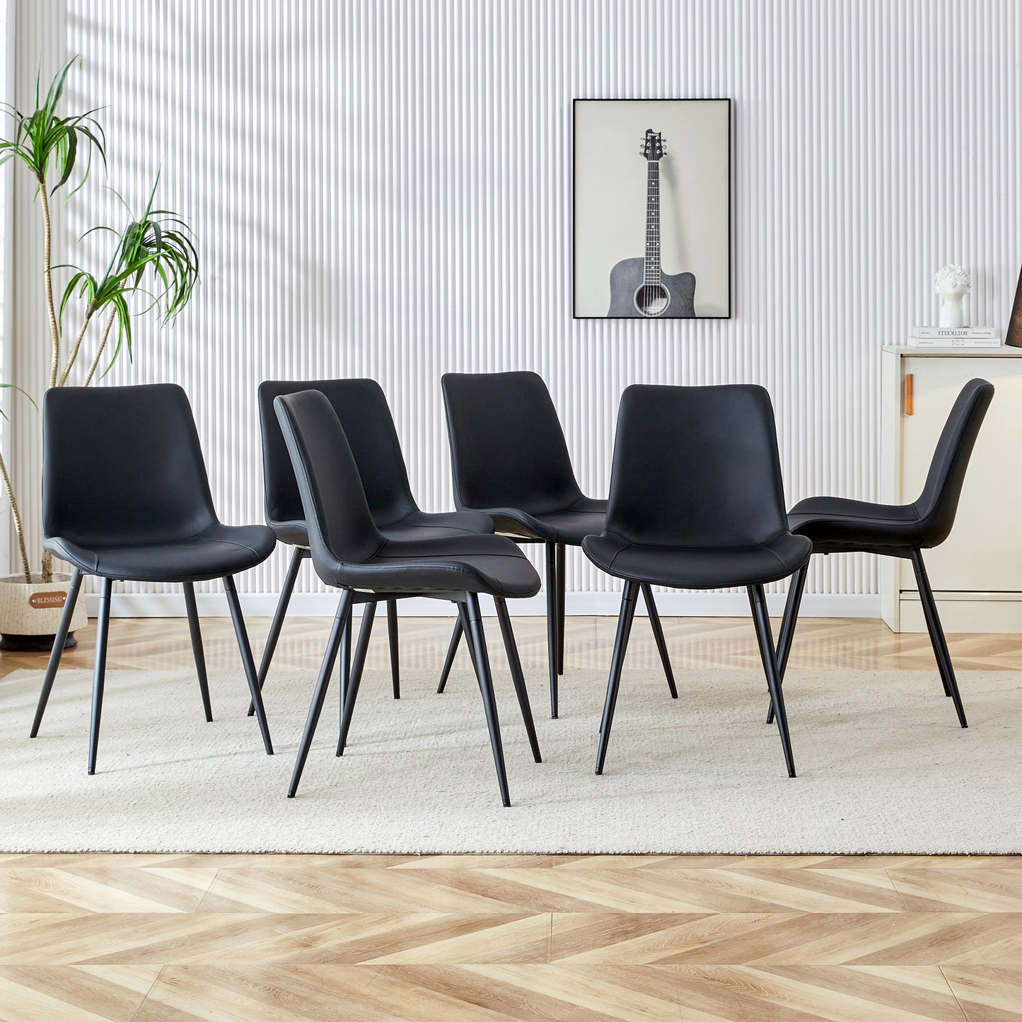 Set of six black faux leather dining chairs with slim metal legs