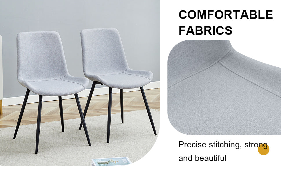 Two light grey fabric dining chairs with black metal legs