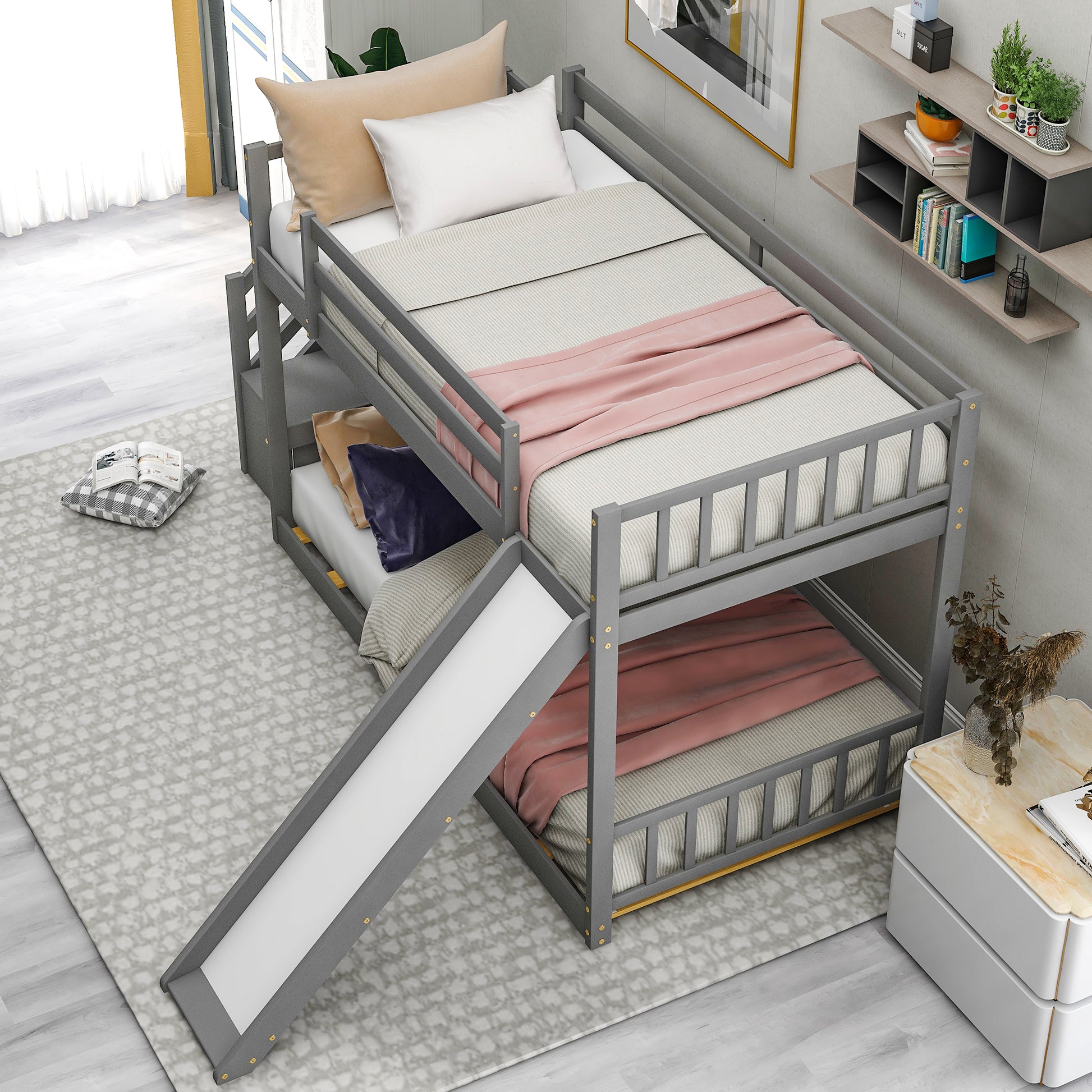 Gray wooden twin over twin bunk bed with slide and pink bedding