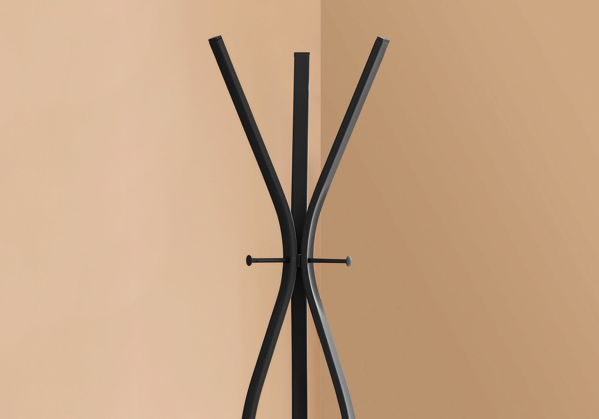 Black metal modern coat rack with curved legs and three hooks