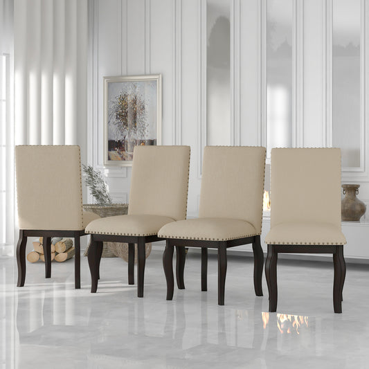 Set of four beige upholstered dining chairs with nailhead trim and dark wood legs