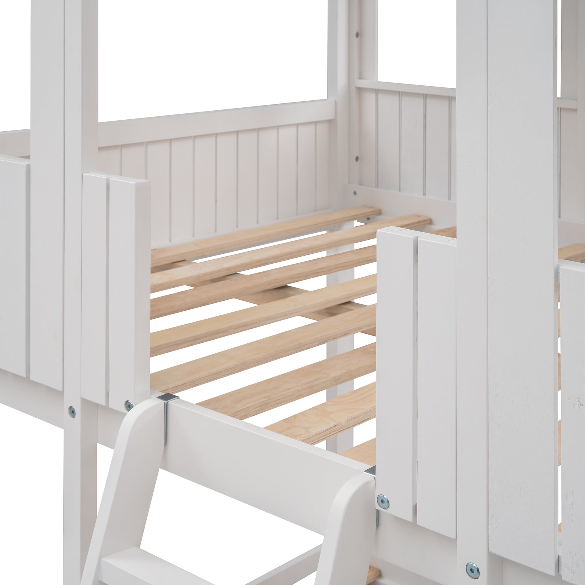 White wooden slatted base of a childrens house bed frame