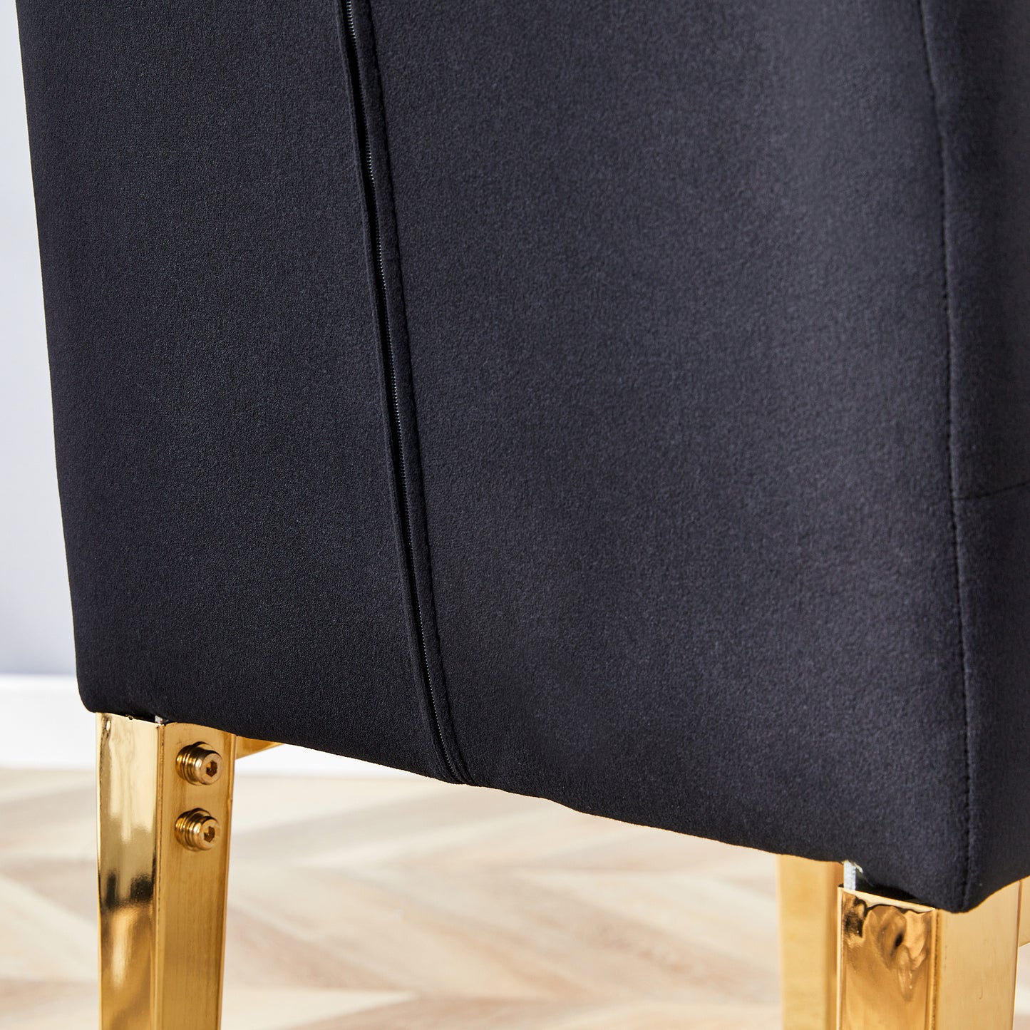 Black fabric accent chair with gold legs