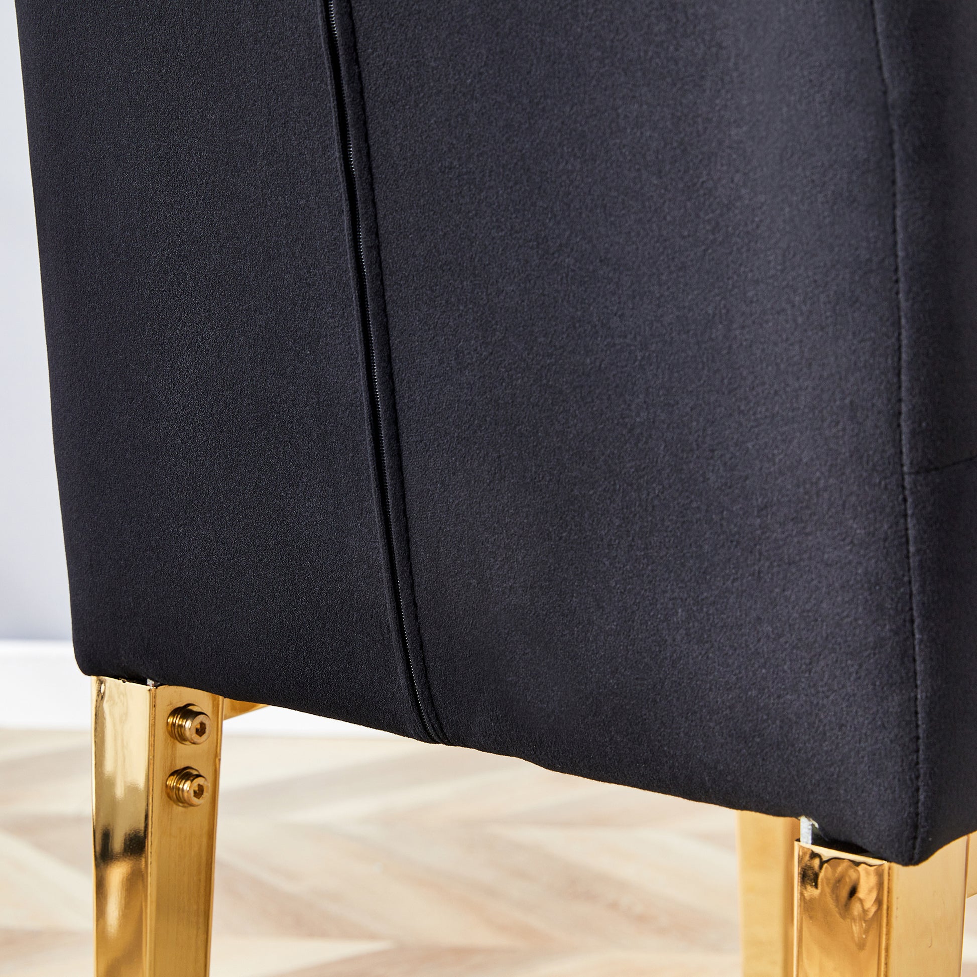 Black fabric accent chair with gold legs