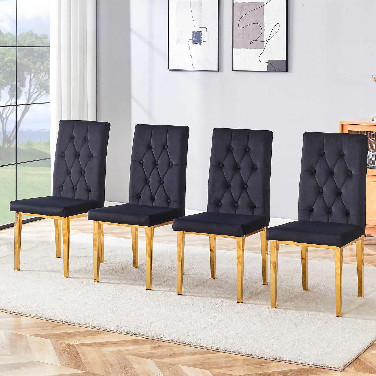 Four black velvet dining chairs with tufted backs and gold legs