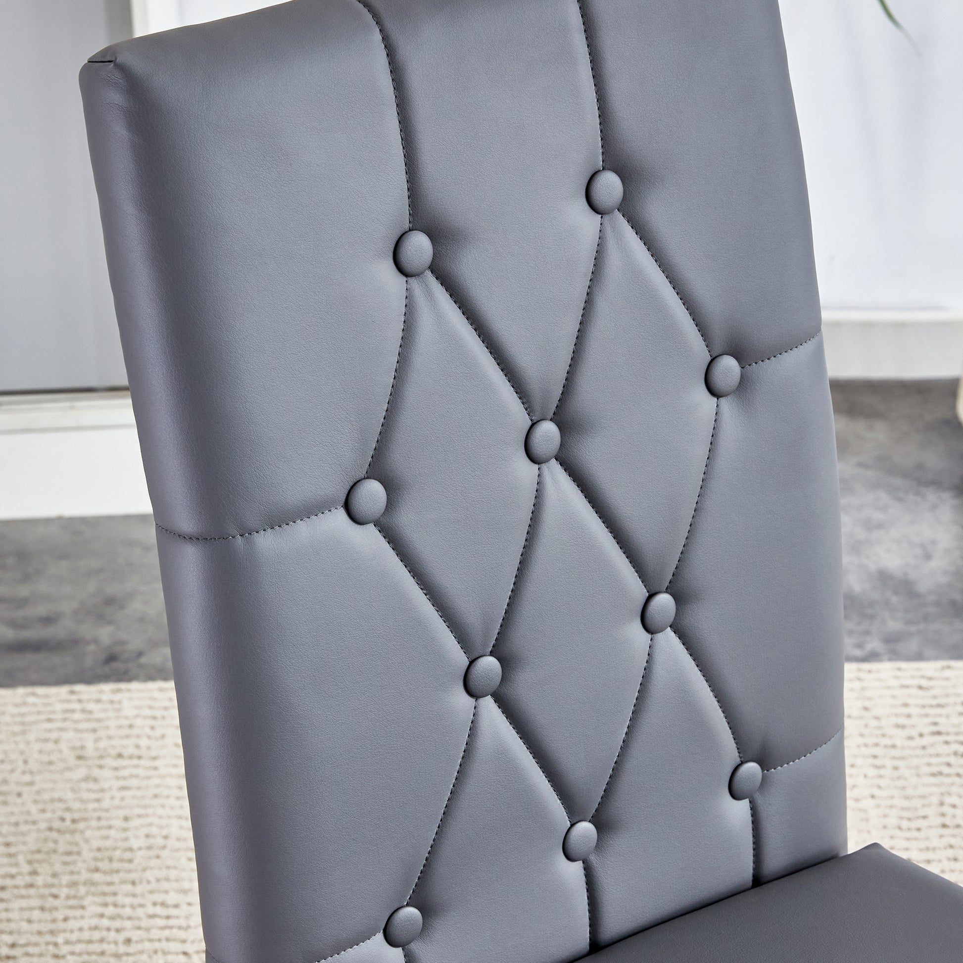 Gray faux leather dining chair with tufted back