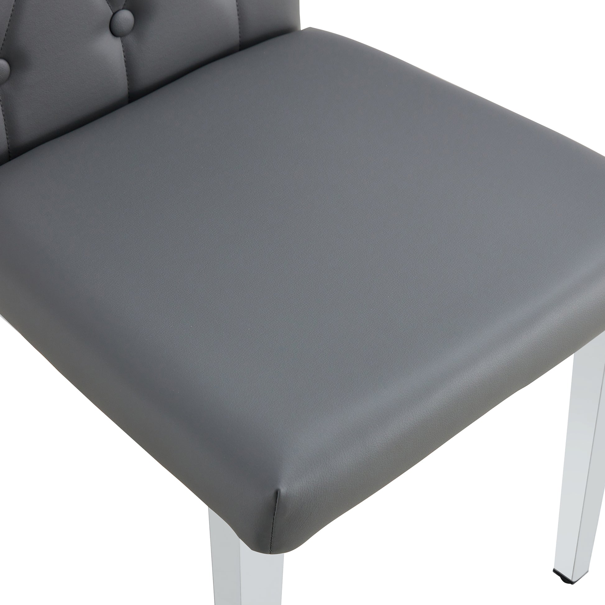 Gray faux leather dining chair with tufted back