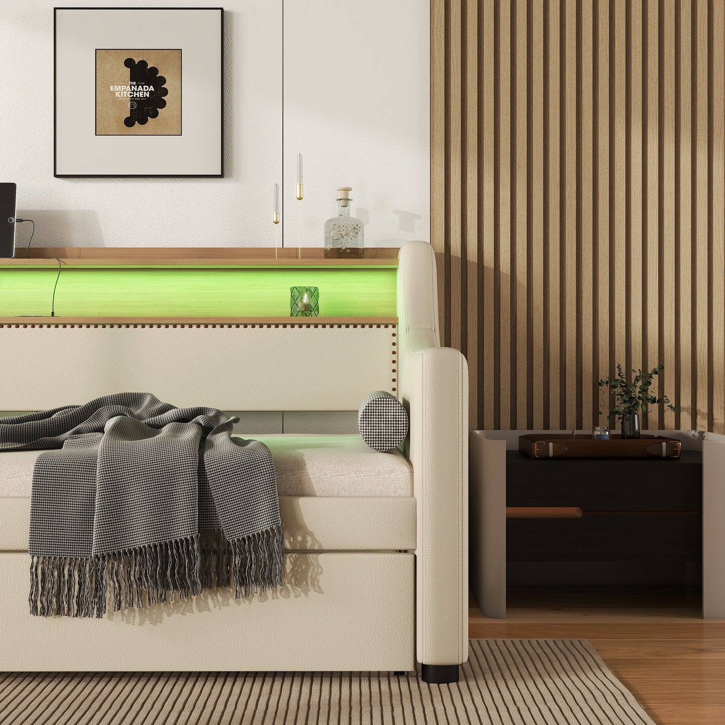 Cream upholstered daybed with studded headboard and plaid throw
