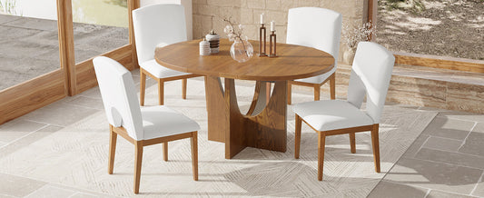 Round oak dining table with four white upholstered chairs