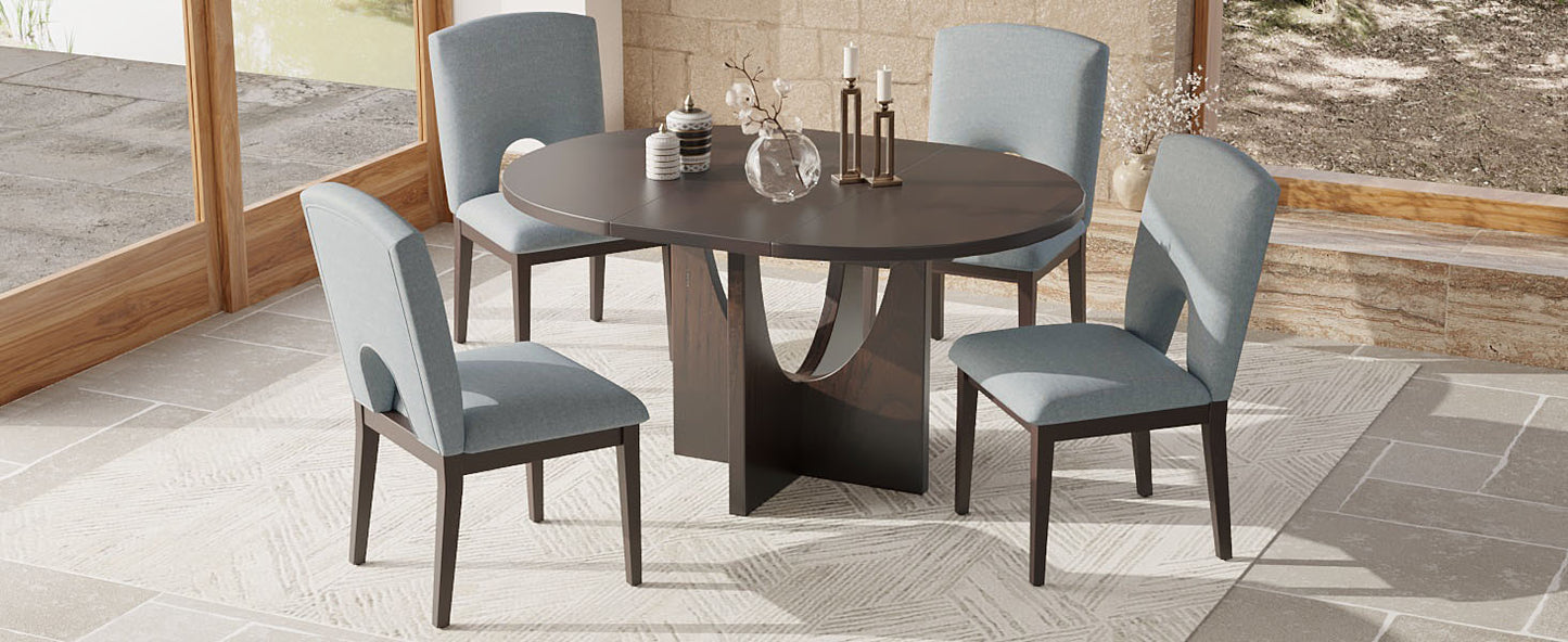 Dark wood round dining table with four upholstered blue chairs