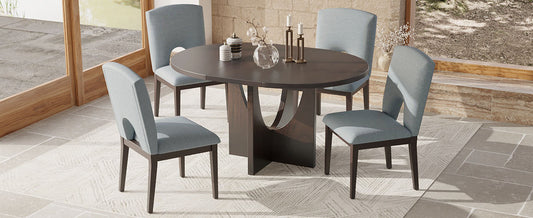 Dark wood round dining table with four upholstered blue chairs